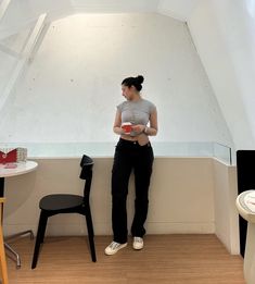 a woman is sitting on the edge of a room