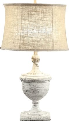 a white table lamp with a beige shade on the top and bottom part of it