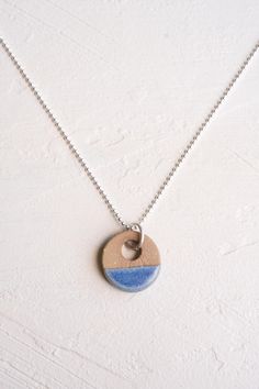 a necklace with a blue and white circle on it