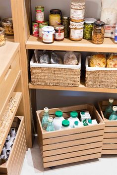 an organized pantry with lots of food and condiments in baskets on the shelves