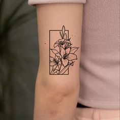 a woman's arm with a flower tattoo on the left side of her arm