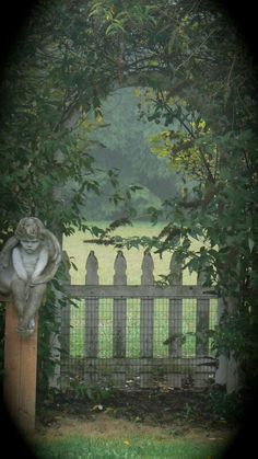 an animal statue sitting on top of a wooden fence