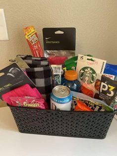 a basket filled with snacks and drinks on top of a table