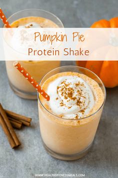 two pumpkin pie protein shakes with cinnamon sticks and an orange pumpkin in the background