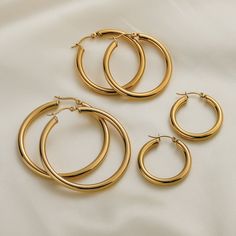 Make a timeless statement with our Gold-Plated Stainless Steel Hoop Earrings. These are the only hoops you'll ever need in your jewelry collection. Crafted with 316 stainless steel and dipped in 18k real gold, these earrings are both lightweight and durable, making them perfect for everyday wear or special occasions. With a weight of only 4g, you won't even notice you're wearing them. These hoops are made to last for years if handled with care. Shop now and experience the ultimate in style and q Earring Sets, Tarnished Jewelry, Pearl Shop, Gold Filled Hoops, Earrings Geometric, Hoops Earrings, Cool Gifts For Women, Hoop Earring Sets, Gold Gift