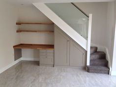 an empty room with some stairs and shelves