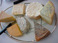 there are many different types of cheeses on this plate, but one is not