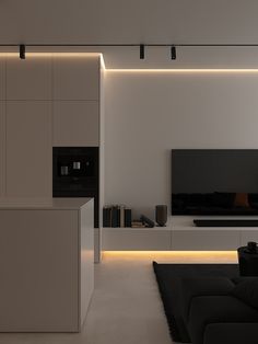 a modern living room with white walls and black furniture in the center is lit by recessed lighting