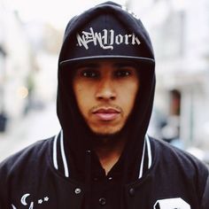 a young man wearing a black hoodie with the word new york written on it