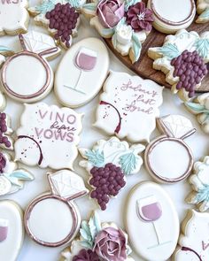 decorated cookies with wedding rings and wine glasses on them are displayed for the guests to enjoy