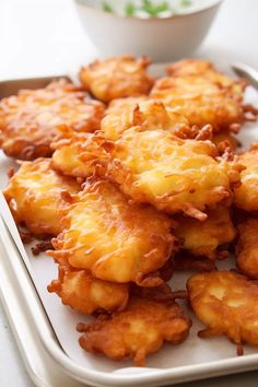 some fried food is on a white tray