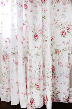 the curtains are covered with floral fabric