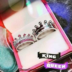 two wedding rings in a pink box with the words king and queen on it