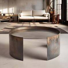 a large metal table sitting in the middle of a living room next to a couch