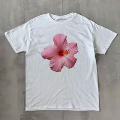 Hibiscus Classic Unisex Tee Hibiscus Classic Unisex Tee, Heavy Cotton Graphic T-Shirt, Iconic Slogan Print - 100% cotton - Classic Unisex fit - Runs true to size (refer to size chart) - Tear-away label - Y2K Vintage Streetwear Trending Fashion - Environmentally sustainable made-to-order system Please refer to the size chart in the listing photos for more sizing details. Don't forget to tag us in any photos or videos :) White Hibiscus Print T-shirt For Spring, Cotton Floral Print Tops For Streetwear, White Tropical Cotton Shirt, White Cotton Hibiscus Print Shirt, White Cotton Shirt With Hibiscus Print, White Cotton Top With Hibiscus Print, Cotton Hawaiian Streetwear Tops, Hawaiian Cotton Tops For Streetwear, White Graphic Print Hawaiian Shirt