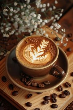 a cappuccino on a saucer surrounded by coffee beans