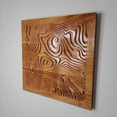 a piece of wood that has been carved to look like an abstract pattern on the wall