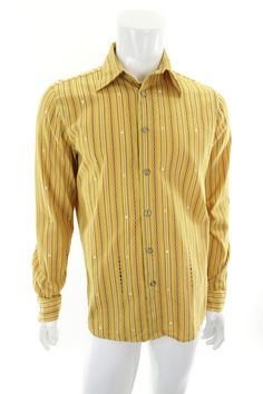 Men's vintage button front shirt by Third Rail Lost Angels. Medium to dark yellow with red, black and white stripes and symbols.  100% cotton, made in USA.  Estimated era: 1990s.  This shirt is collared with a full button front and long button cuff sleeves. There are no pockets.    Very good vintage condition with light wear and a tiny faint spot on the back as shown in photo. Has been cleaned and is ready to wear. Size on tag: Large. To help ensure a good fit please go by measurements, taken flat and buttoned: Armpit to armpit: 23.5" Shoulders: 17.75" Sleeves from cuff to shoulder seam: 27", cuff to middle of back of neck: 36" Top of shoulder to hem: 29"  Waist across front and doubled: 46"  S H I P P I N G We ship within Canada using Canada Post and / or Chit Chats Express. Rates vary ac Yellow Cotton Shirt With Buttons, Yellow Cotton Button-up Shirt, Yellow Retro Top With Button Closure, Vintage Striped Cotton Shirt, Retro Yellow Shirt With Buttons, Retro Cotton Shirt With Buttons, Yellow Retro Shirt With Buttons, Vintage Yellow Collared Shirt, Mustard Long Sleeve Cotton Shirt