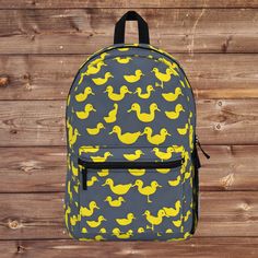 "Here's a delightful surprise for your little scholar - our Duck Backpack! This charming child backpack is designed to make going back to school a whole lot of fun. Crafted with care, it provides ample space for books, stationery, and even a lunchbox. The cool duck motif adds a touch of whimsy to your child's school essentials. From the first day of school to daily adventures, this gift-worthy bag will be their trusty sidekick. Get ready to make this school year extra special with our Duck Backpack! Have you got room for all that? With our roomy and durable backpack, you will! This bag is made from spun polyester and weights 1.3 lbs, just enough to be light, strong and long-lasting. Grab it, stow it, throw it onto the seat next to you, this backpack can take it, and so will you, wherever y Book Bag For School, Duck Backpack, Bag For School, Backpack Cute, School Bookbags, Back To School Backpacks, Yellow Duck, Sewing Tags, School Essentials