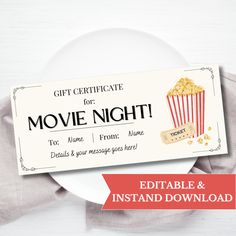 a movie ticket sitting on top of a white plate next to a red and white napkin