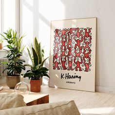 a living room filled with furniture and potted plants next to a painting on the wall