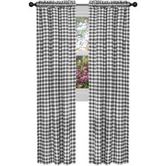 black and white checkered curtains hanging on a window sill with pink flowers in the background