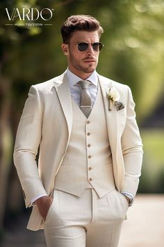 a man in a white suit and sunglasses