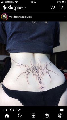 a woman's lower back tattoo with vines on her stomach and the bottom part of her body