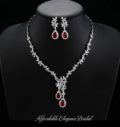 a necklace and earring set with red stones