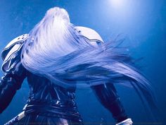 a woman with white hair standing under water