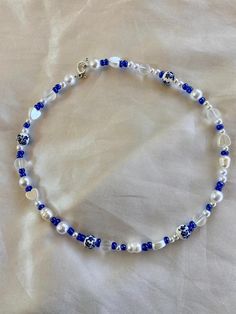 This beautiful blue beaded necklace is made with a variety of different types beads! No specific pattern so each necklace is different! This necklace is 15 inches long! Happy shopping Blue Crystal Necklaces With Polished Round Beads, Blue Necklaces With Adjustable Oval Beads, Blue Crystal Necklace With Polished Round Beads, Blue Oval Beads Necklace With Beaded Chain, Blue Bohemian Pearl Necklace For Gift, Blue Oval Beaded Beads, Blue Beaded Crystal Necklaces With Round Beads, Blue Beaded Crystal Necklace With Round Beads, Handmade Blue Beaded Necklaces With Oval Beads