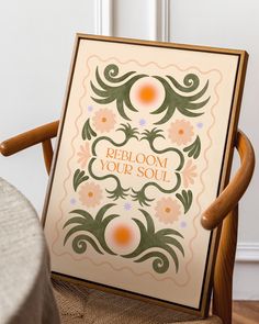 a wooden chair with a sign on it that says, bloom your soul and an orange flower in the center