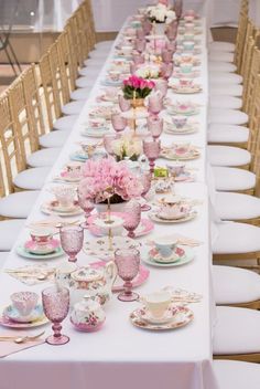 a long table with plates, cups and vases on it is shown in an instagram