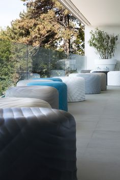 there are many mattresses lined up on the floor in front of a glass wall