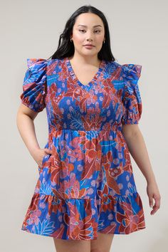 You'll always be dressed and ready for fun adventures in the Amazonia Blue Leones Smocked Mini Dress! Features a Ruffle trim V neckline and fully smocked bodice framed by short puff sleeves. It tops a flared ruffle tier mini skirt. Wear it with red heels to match this gorgoues mini dress!- Breathable- Smocked bodice- Ruffle details- Pockets- Color: Blue RedSize + Fit - Model is 5'10" and wearing size 2X- Measurements taken from size 2X- Chest: 21 1/4"- Length: 39 1/2" Fabric Self:100%Cotton Styl Vacation Smocked V-neck Dress With Smocked Cuffs, Vacation V-neck Smocked Dress With Smocked Cuffs, V-neck Smocked Dress With Smocked Cuffs For Vacation, Blue V-neck Smocked Dress For Spring, Spring V-neck Blue Smocked Dress, Spring Blue V-neck Smocked Dress, Blue V-neck Smocked Dress, Blue Short Sleeve Smocked Dress For Beach, Blue Beach Dresses With Smocked Cuffs