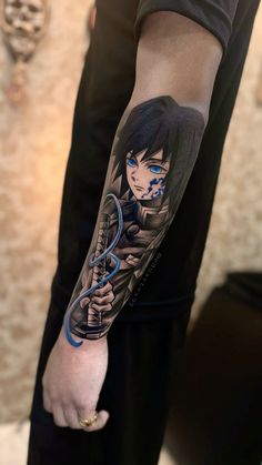 a man's arm with an anime character tattoo on the left side of his arm