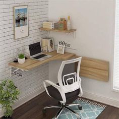 a computer desk with a laptop on top of it next to a potted plant