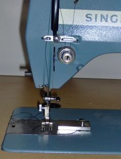 an old sewing machine sitting on top of a wooden table