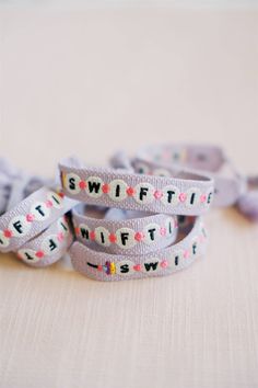 three bracelets with words on them sitting on a table