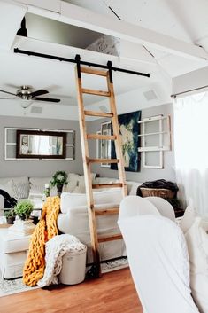 a living room filled with furniture and a ladder