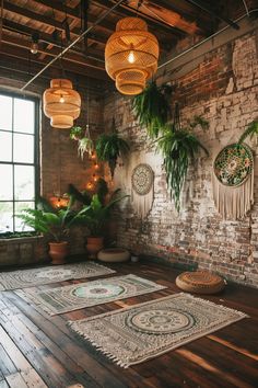 a room with plants and rugs on the floor in front of a brick wall