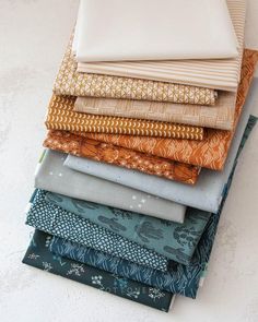 a stack of different colored fabrics sitting on top of each other