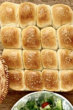 a table topped with bread rolls and a salad