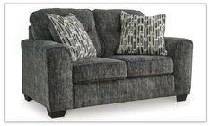 a gray couch with two pillows on it