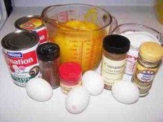 an image of ingredients for cooking on the counter top with eggs and other things to put in them