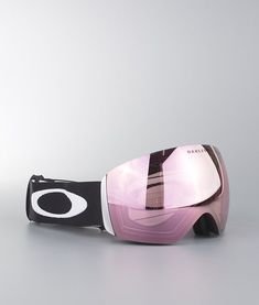 a pair of ski goggles sitting on top of a white table next to a gray wall