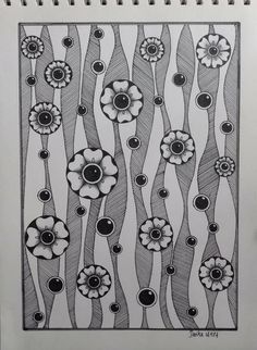 a drawing with black and white flowers on it's side, in front of a spiral