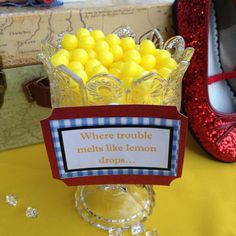 there is a glass vase filled with yellow candies