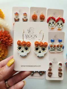 the earrings are decorated with skulls and flowers