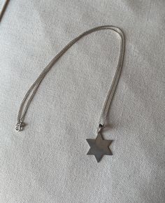 Vintage Sterling Silver Star Necklace. Marked 925. Really pretty & cute. Would make a lovely gift.  MEASUREMENTS  Length: 52cm  Pendant: 2 x 2cm  CONDITION  The necklace seems to be in good condition. It is vintage and preloved so bear that in mind before buying. There maybe come scuffs or defects I've missed when looking it over Star-shaped Engraved Necklace For Gift, Sterling Silver Star-shaped Engraved Necklace, Silver Star Of David Charm Necklace For Gifting, Silver Star Of David Charm Necklace As Gift, Silver Star Of David Charm Necklace For Gift, Engraved Star-shaped Sterling Silver Necklace, Engraved Star White Gold Necklace, Silver Star-shaped Personalized Necklace, Silver Star Of David Necklace For Gift